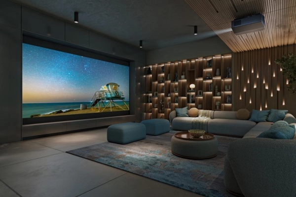 A casual home theater with a sectional, beautiful lighting, a Sony projector, and a large screen.