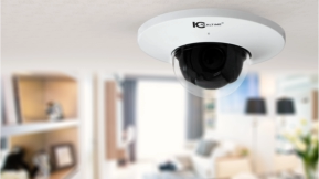 An IC Realtime outdoor security camera is mounted near a tranquil pond surrounded by trees, monitoring the natural landscape.