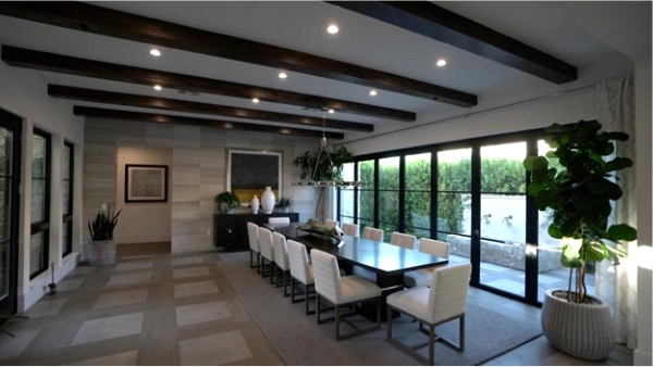 dining room with exposed ceiling beams, recessed lighting, large windows, and hidden in-wall Sonance speakers for a clean, elegant look.