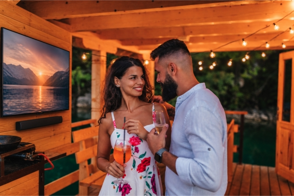 A couple enjoying the ambiance of their dock house with all encompassing professional sound and video