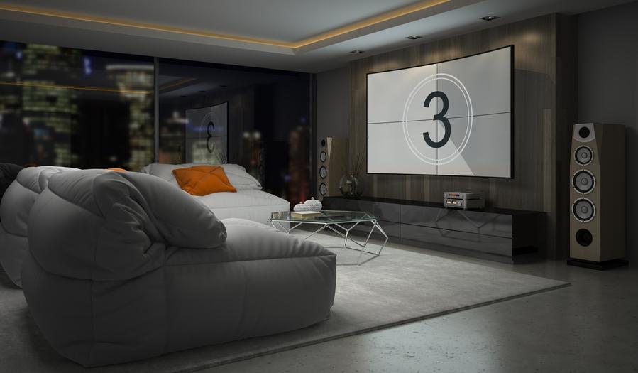 Modern media room with a large projection screen, surround sound speakers, and comfortable lounge seating.
