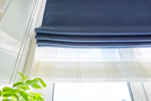 Close-up of a roman blind in a royal blue color