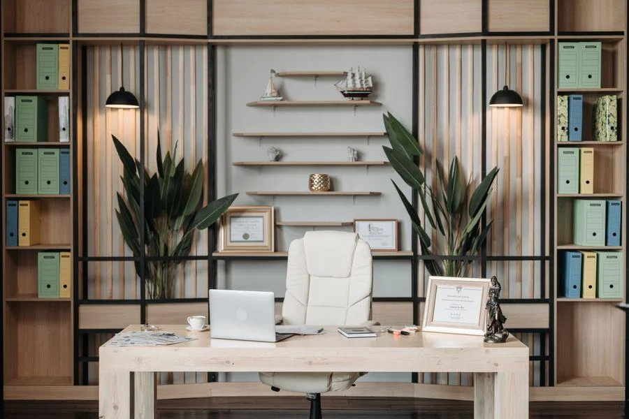 Modern home office with a wooden desk, built-in shelving, and contemporary décor.